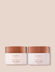 Inika Organic Phytofuse Renew Day and Night Creams with bronze lids against a beige background.