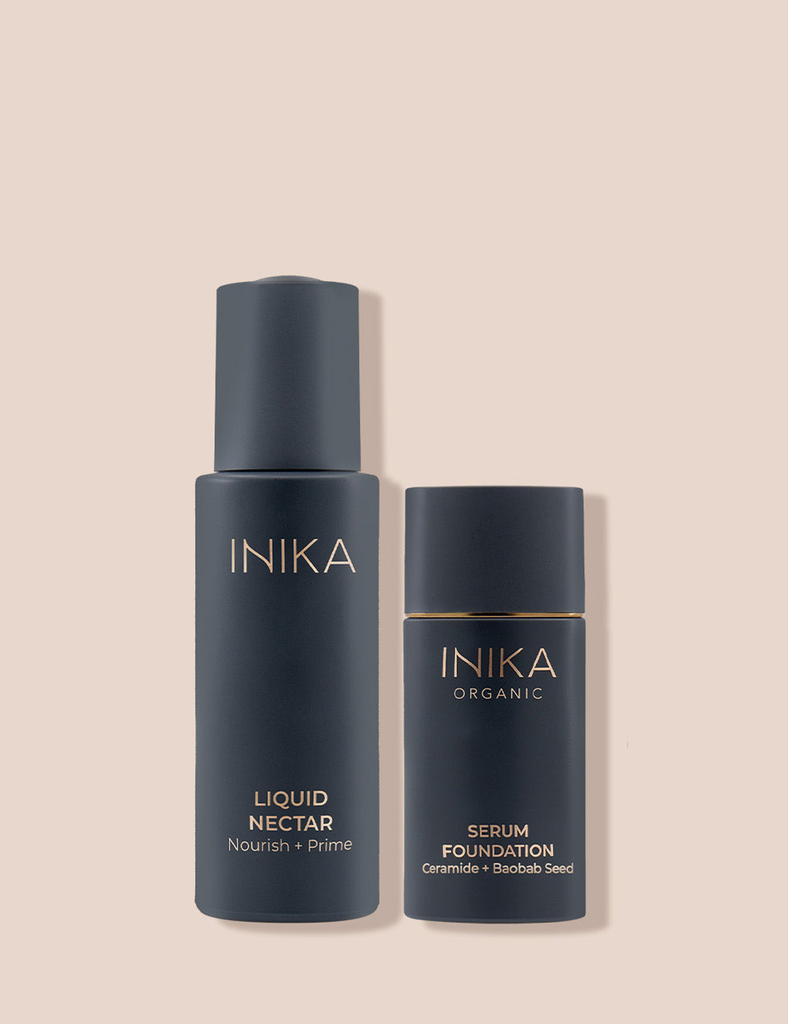 Two dark grey bottles on a beige background: Inika Liquid Nectar, and Serum Foundation with organic ingredients. Minimalist luxury skincare packaging.